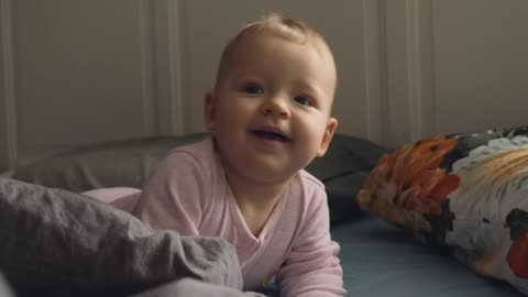 Restless baby smiling at the camera #Baby #cutebaby