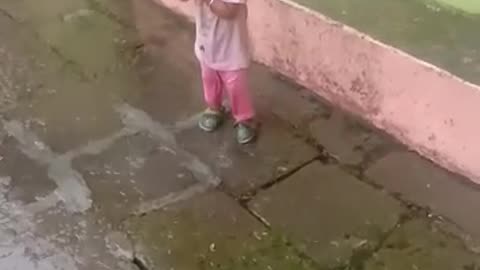 Litle baby enjoy in rain