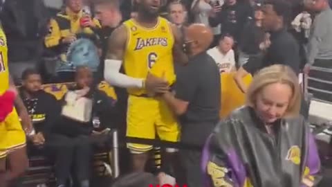 LeBron James has to be held back by security