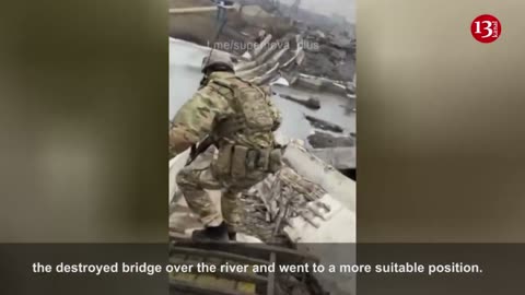 Under fire, Ukrainian fighters are crossing the river through a destroyed bridge in Bakhmut