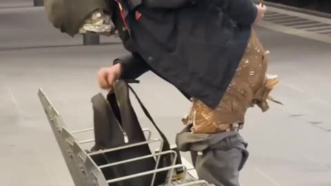 Homeless Man Taping Up To Stay Warm