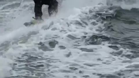 Guy water skiing in a suit