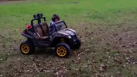 Kid adorably falls asleep while driving utility vehicle