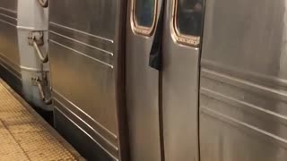 Clothing sticking out of subway train doors