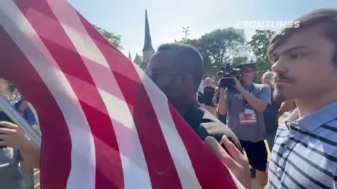 COMMIE protester tries to steal an American flag from a REAL AMERICAN