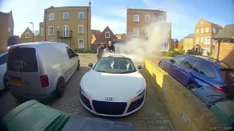 Expensive Audi is burning roadside and the owner extinguished the fire immediately