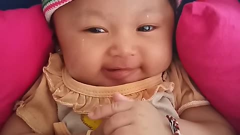 Little girl laughing funny on the pushchair.