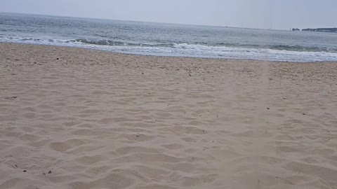 Dropping sand on Bournmouth beach . Slow motion