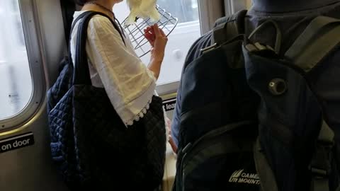 Woman in white shirt carrying white yellow bird