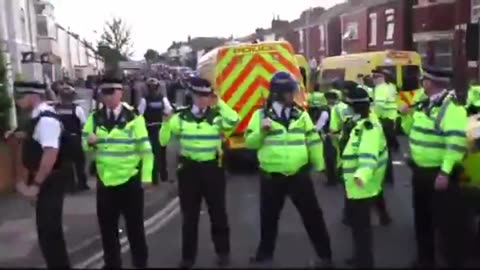 Police and Riot Squad are surrounded by protesters in Southport, England, where 3 girls were slain