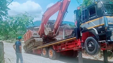 Excavator Riding on Trado Car