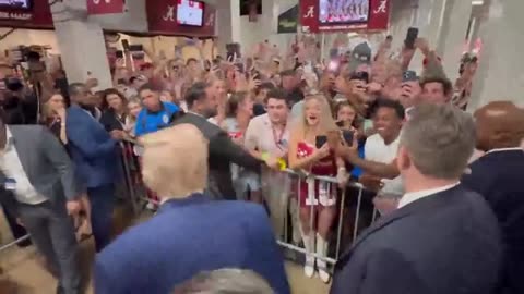 : Trump tosses boxes of food to waiting fans at college football game