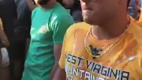 Guy in yellow shirt cracks beer on a girls head then chugs it