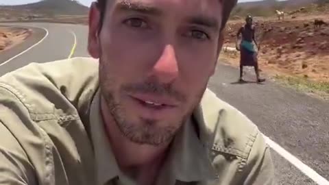 White man biking through Africa gets spears and rocks thrown at him LMFAO