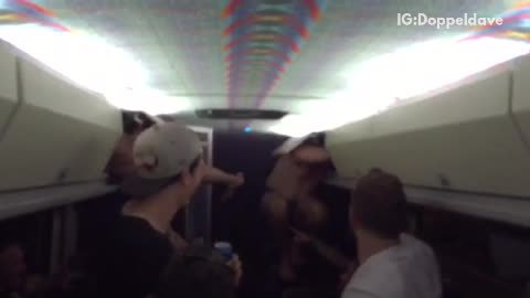 Guys hiding in overhead bins on bus