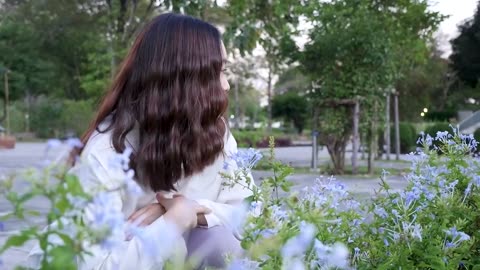 Asian girl beautiful smile smelling flowers