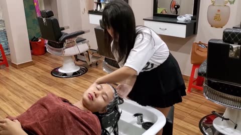 Vietnamese barber shop, relaxing shampoo and facial massage with beautiful girl