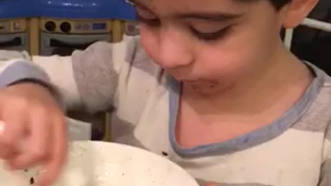 Boy can't get enough chocolate cake and vanilla ice cream