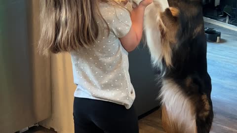 Girl Sweetly Serenades Dog