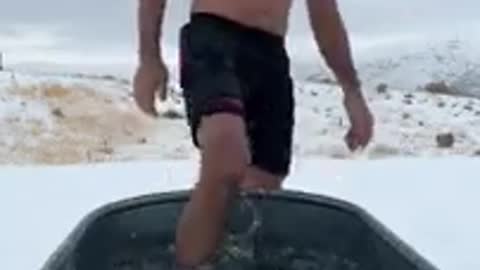 white man taking bath in extreme cold water winters