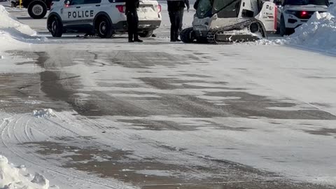 Skid Loader Plows Into Police Cruiser