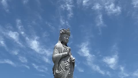 Buddha statue located high up in the sky