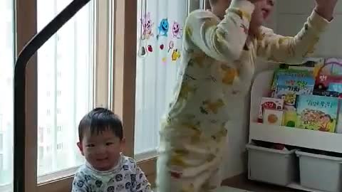 Babies having fun on a mini trampoline.