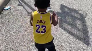 Toddler Drills A Long Distance Basketball Shot With Ease