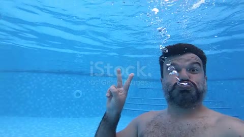 Man diving in pool ok sign