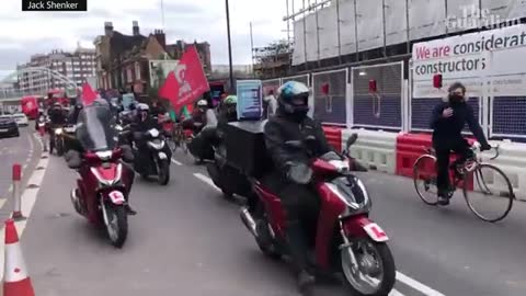 Deliveroo riders stage ride-along strike in London