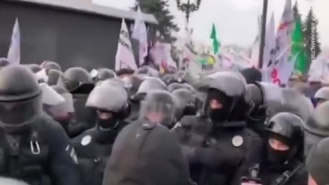 crowds the streets of the Ukrainian capital, clashing with police