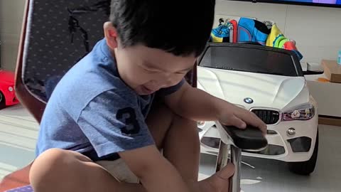 Korean cute baby playing with a turning chair