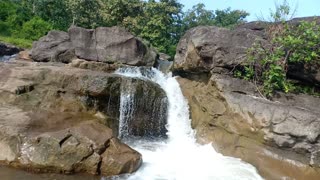 Small Waterfall flowing over Rocks