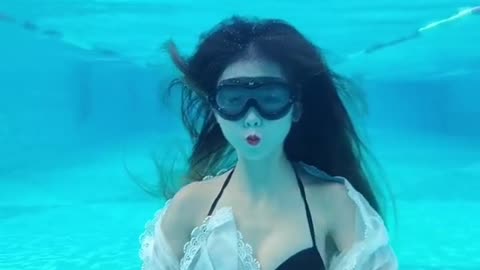 Beautiful girl dancing underwater