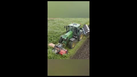 The land is being plowed with a tractor