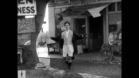 Charlie Chaplin cycling down a tightrope