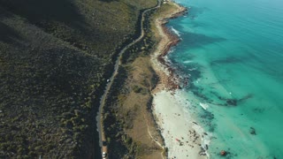 A mountain road overlooking the beach