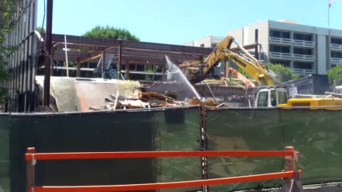 A Building being Demolished by Excavator Arm