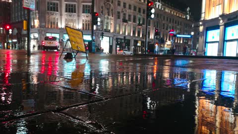 Los Angeles Footage Of The Wet Pavement Of The Sidewalk With A Signage On A Rainy Night In The City