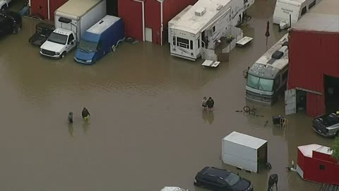 Deadly floods strand travelers as storms move east