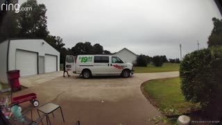 Thoughtful FedEx Driver Wraps Package on Rainy Day