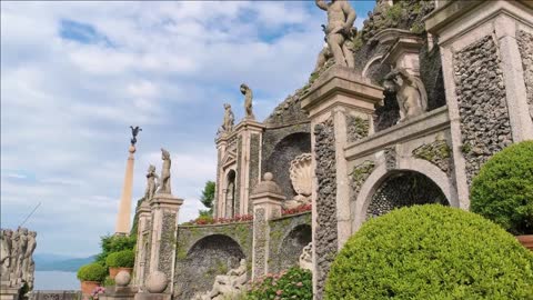 statues of children sculptures plants and sky visiting the isola bella garden