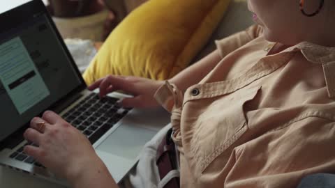 Woman Using Laptop on the Couch with dog