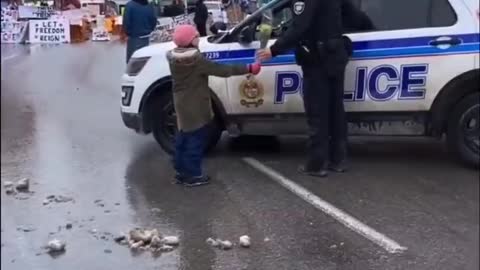 Precious: Little Girl Offers Canadian Agent of the State Flowers At Trucker Protest