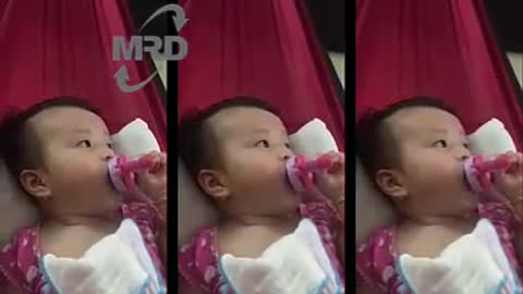 Baby drinking bottle milk - 3 months old