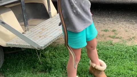 Adorable Explorer Clutches a Slithery Catch