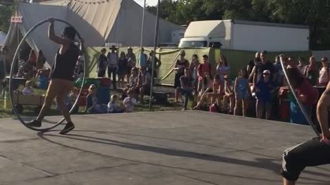 Acrobats ride large hula hoops in Glastonbury