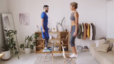 Couple Doing Step Aerobics Using Chairs