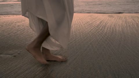 Feet walking on the beach