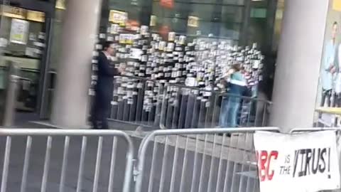 The windows of the BBC studios have been covered in photos of people killed by the jab